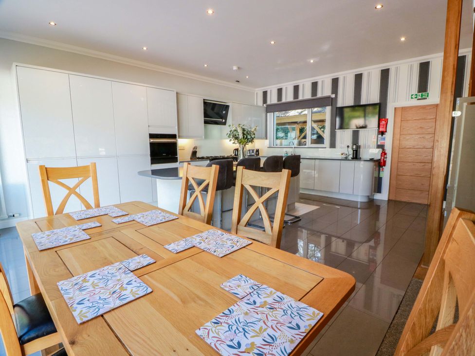 A kitchen with dining area and cabinets at Castle House Lodge in Glasgow