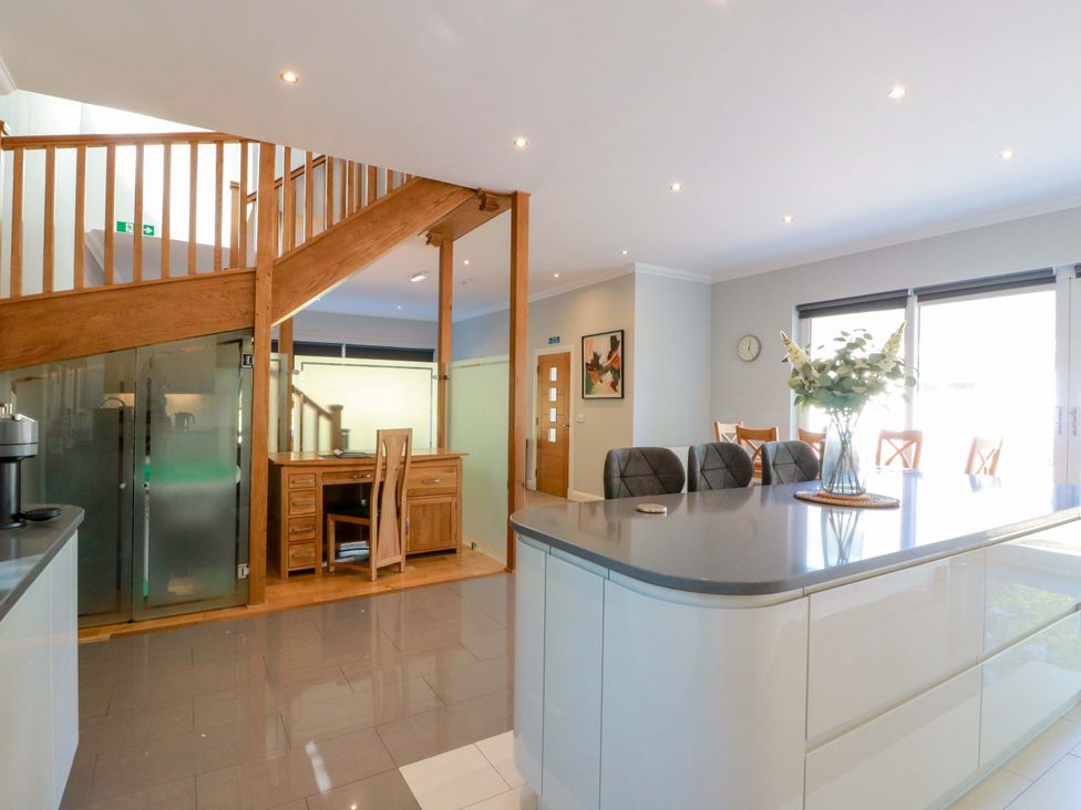 A kitchen with a desk and staircase at Castle House Lodge in Glasgow
