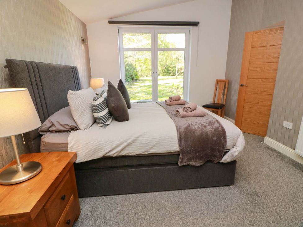 A bedroom with a bed and a window at Castle House Lodge in Glasgow