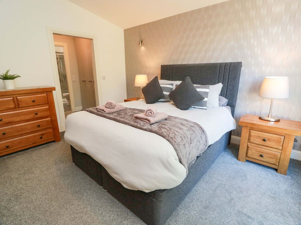 A bedroom with a bed and lamp at Castle House Lodge in Glasgow