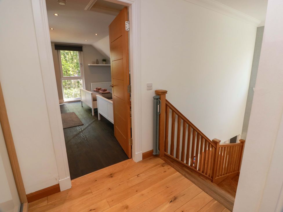 A hallway with a staircase and a window at Castle House Lodge in Glasgow
