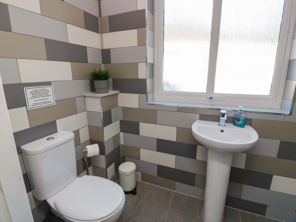 A bathroom with a toilet and sink at Castle House Lodge in Glasgow