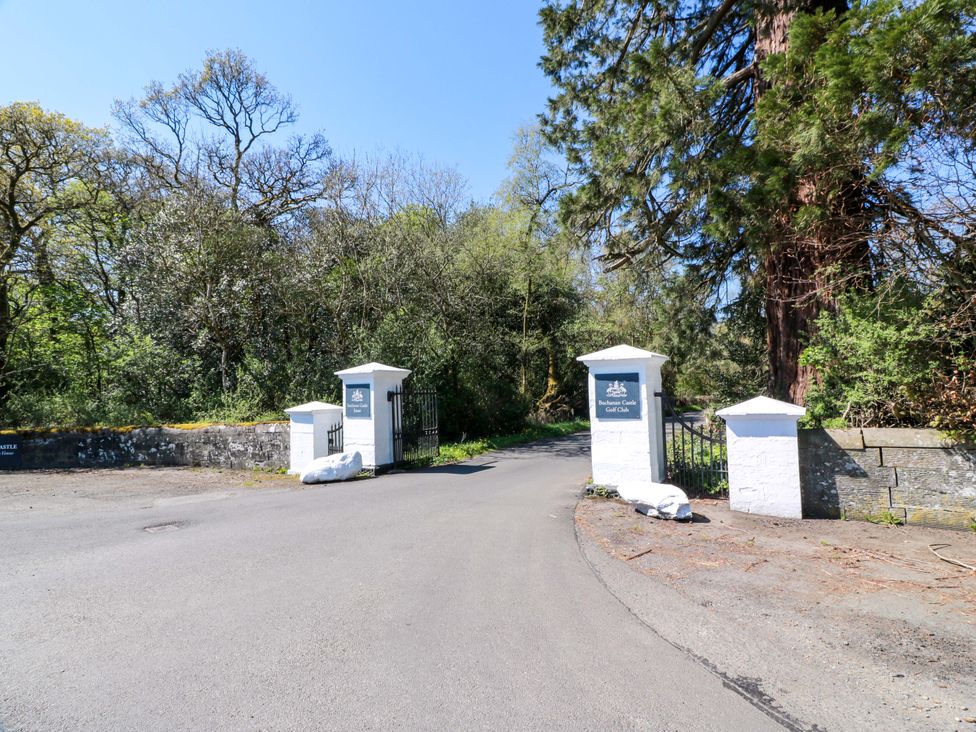 Gates leading to a property surrounded by trees at Castle House Lodge Glasgow