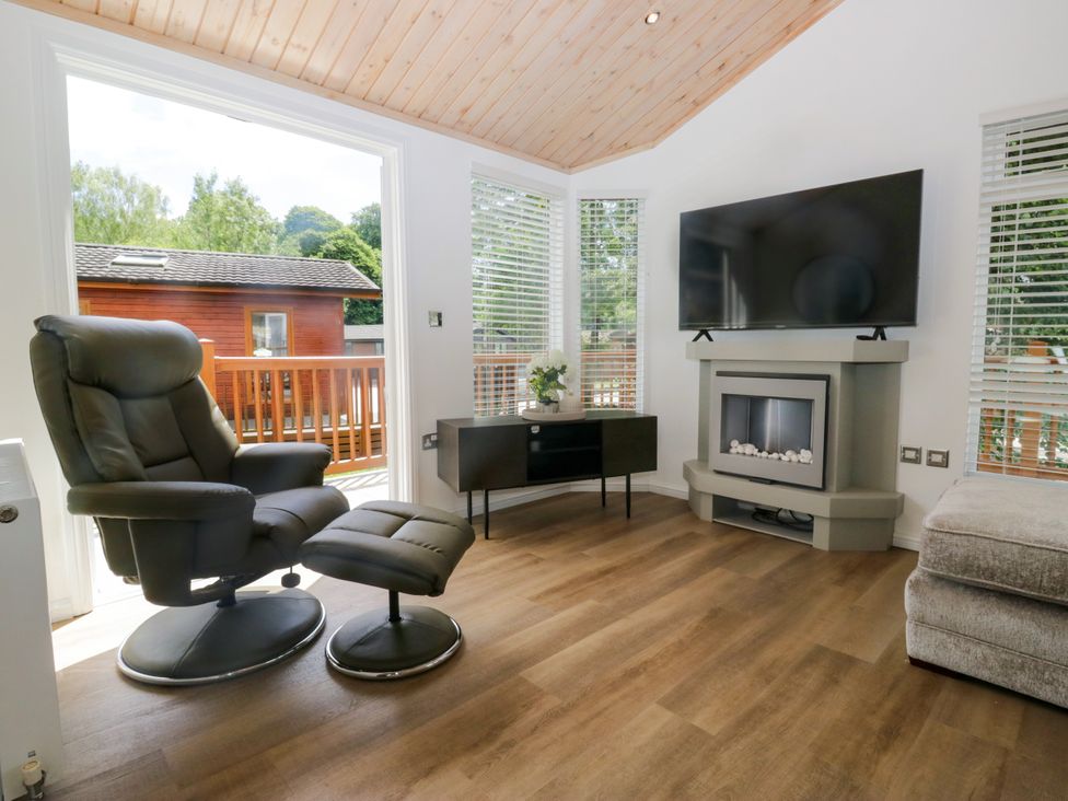 A living room with a recliner chair and television at Fox Red Retreat in Troutbeck Bridge