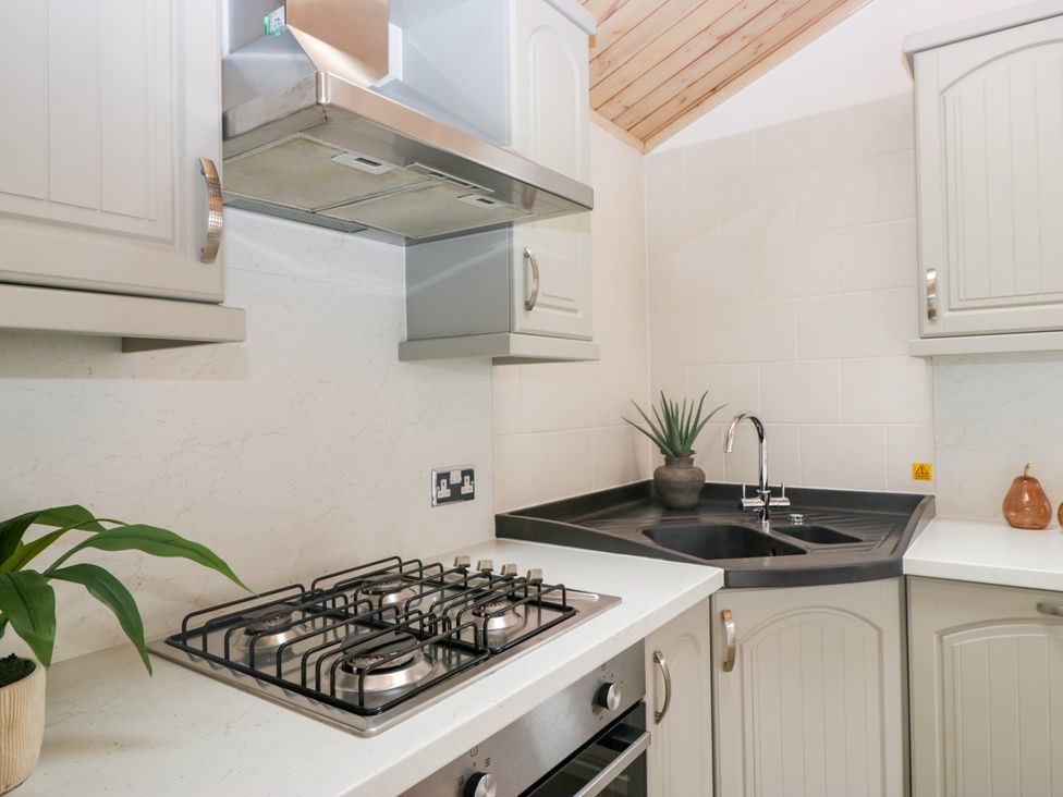A kitchen with a gas stove and sink at Fox Red Retreat in Troutbeck Bridge