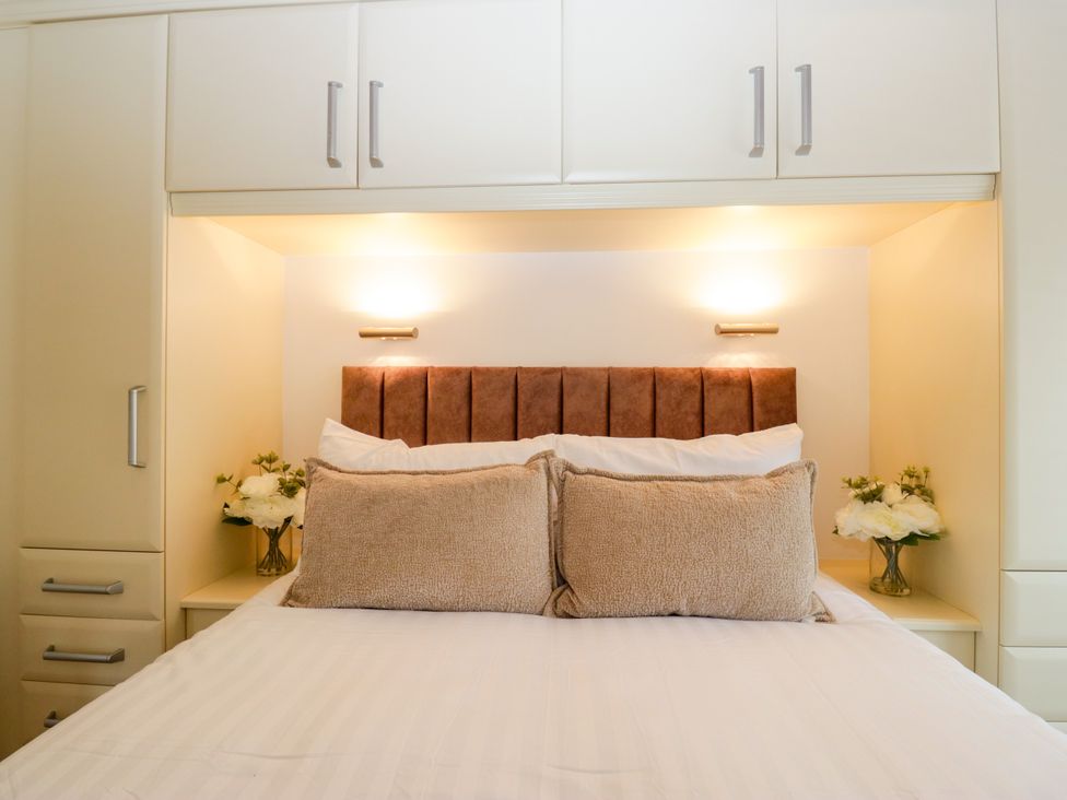 A bedroom with a bed and pillows at Fox Red Retreat in Troutbeck Bridge