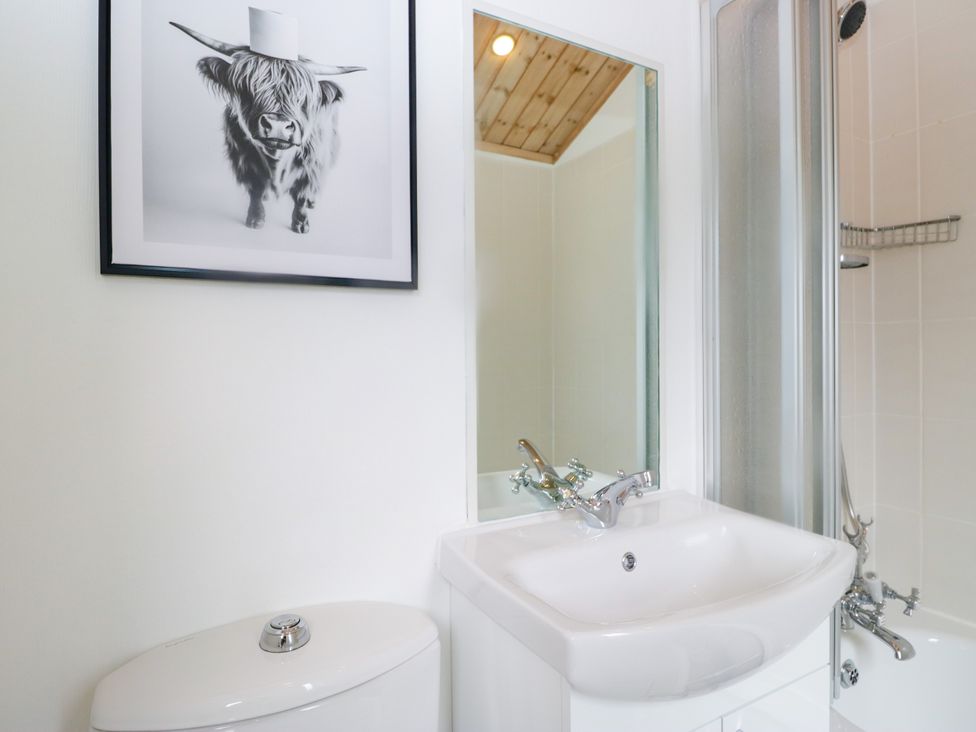 A bathroom with a sink, toilet, and shower at Fox Red Retreat in Troutbeck Bridge