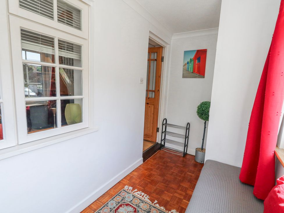 A hallway with a window and a door at 12 West Street Weymouth