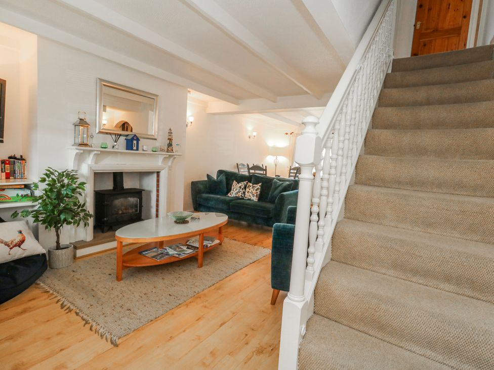 A living room with a staircase and sofa at 12 West Street Weymouth
