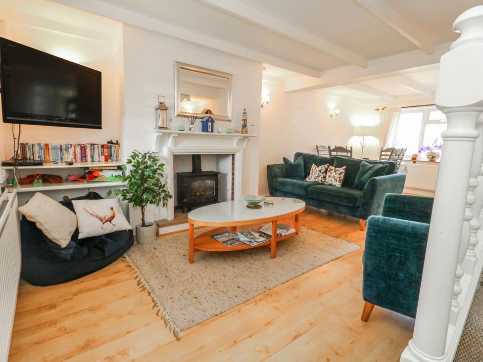 A living room with a fireplace and sofa at 12 West Street in Weymouth