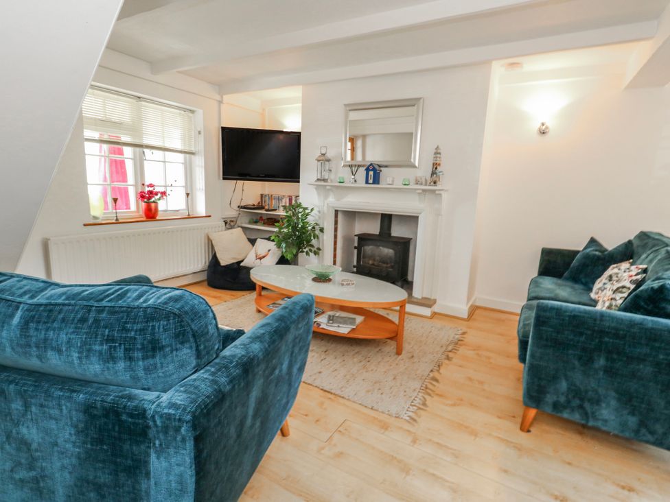 A living room with sofa and television at 12 West Street, Weymouth