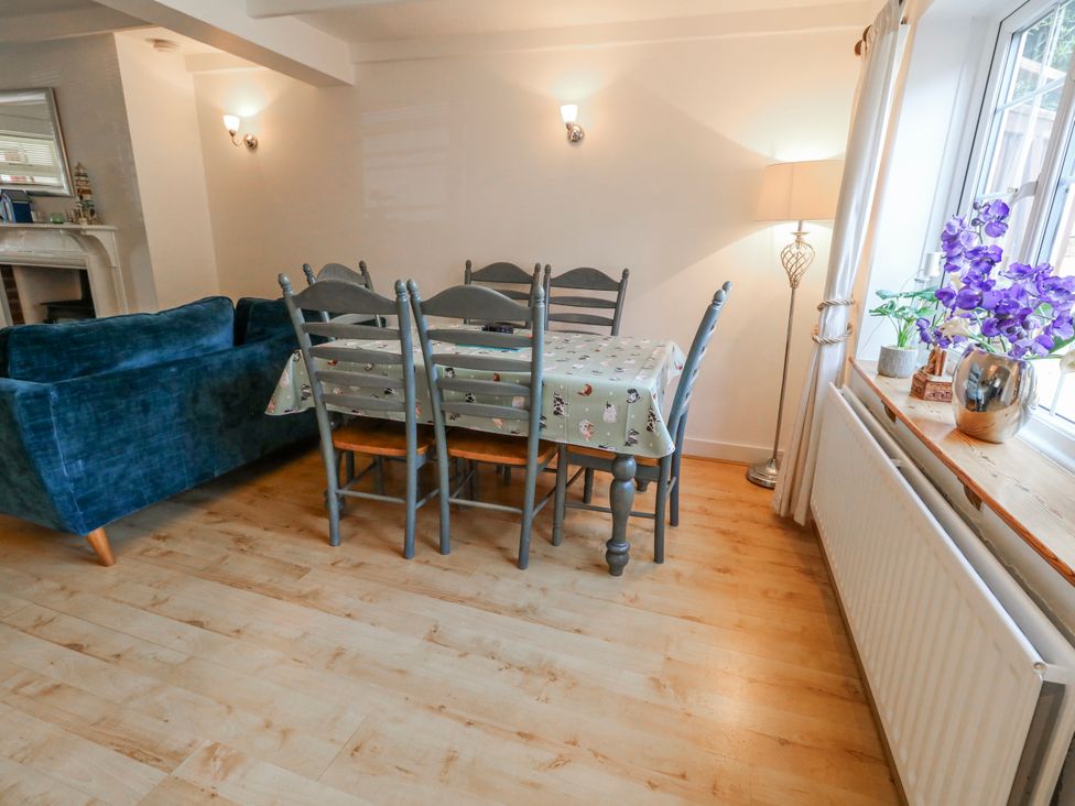 A dining room with a table and chairs at 12 West Street in Weymouth