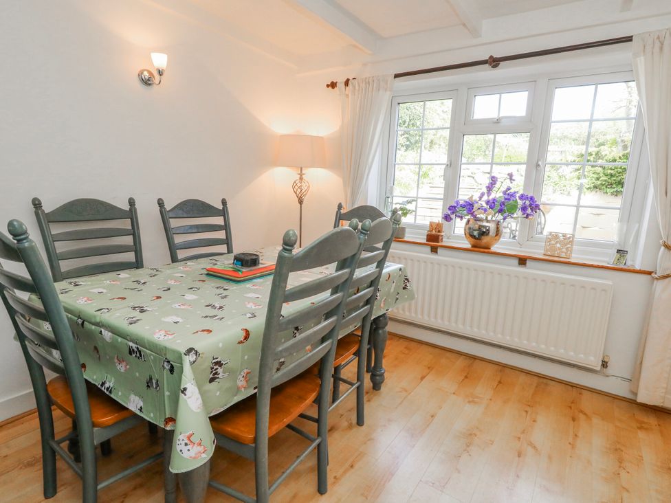 A dining room with a table and chairs at 12 West Street Weymouth