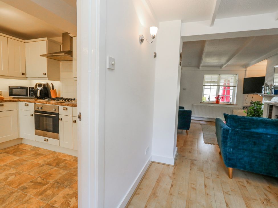 A kitchen with a view of the sitting area at 12 West Street Weymouth