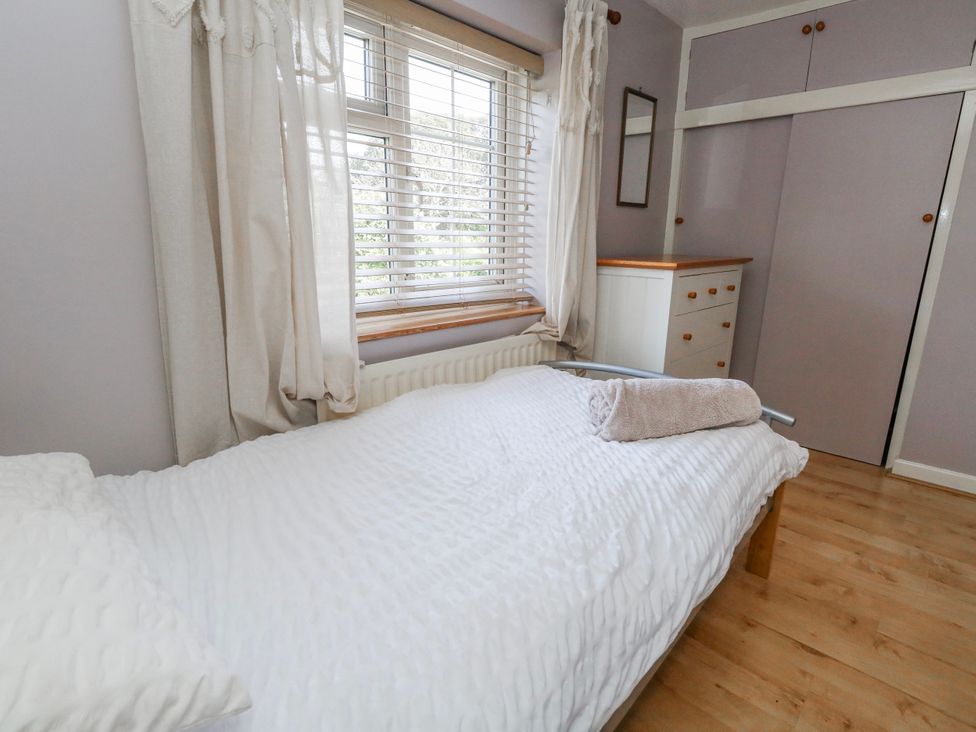 A bedroom with a bed and a wardrobe at 12 West Street in Weymouth