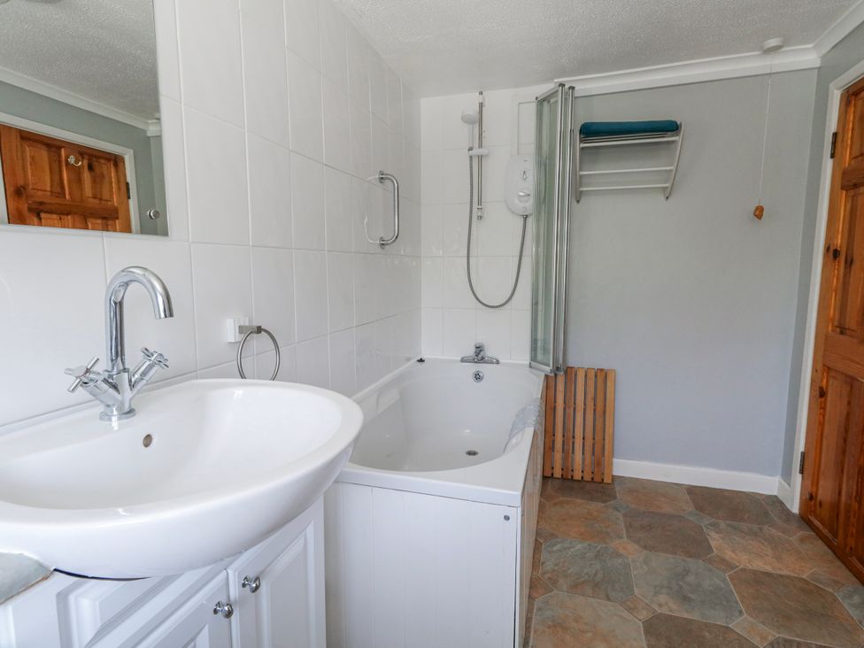 A bathroom with a bathtub and sink at 12 West Street Weymouth