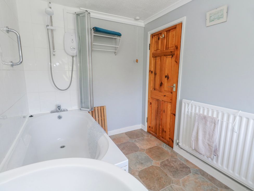 A bathroom with a bathtub and shower at 12 West Street Weymouth