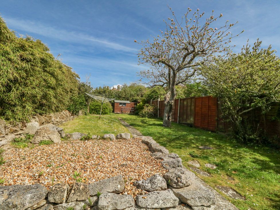 A garden with a gravel area and trees at 12 West Street Weymouth