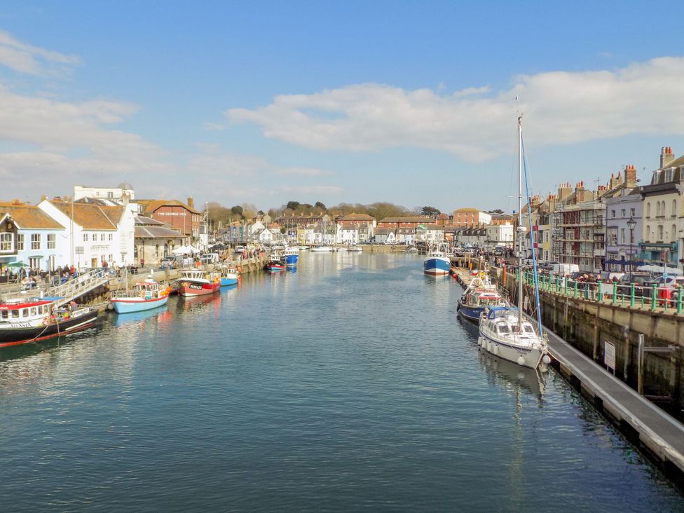 A harbor with boats and buildings at 12 West Street Weymouth
