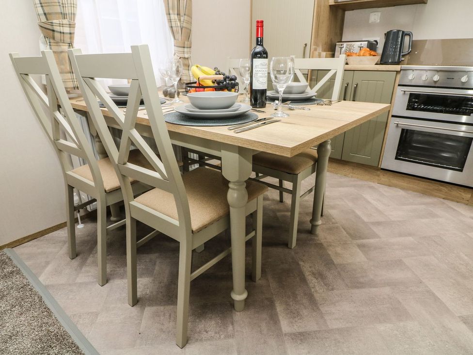 A dining room with a table set for dinner at Hedgehog Lodge in Carnforth
