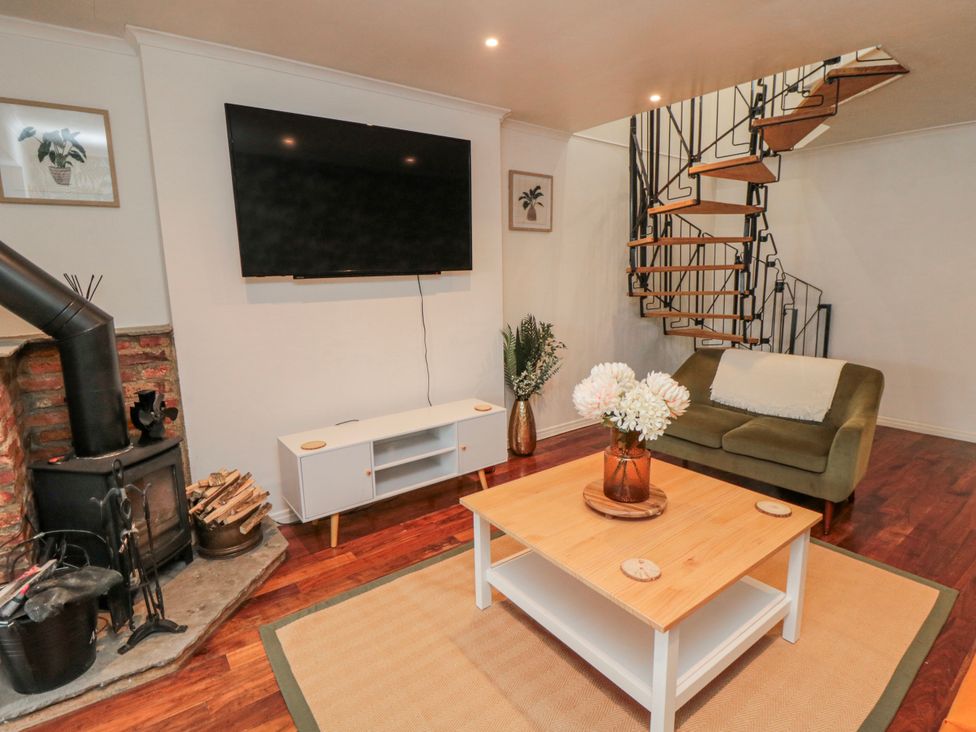 A living room with a sofa and television at 3 Beck Mews in Scarborough