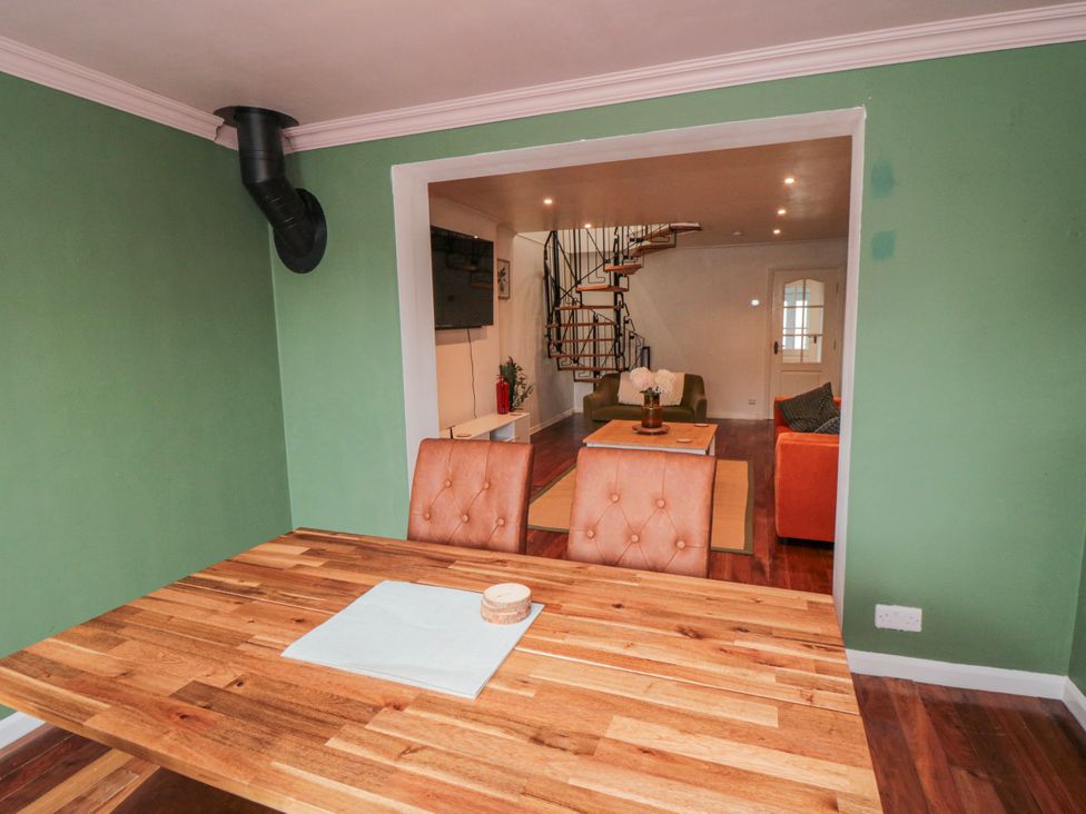 A dining room with a table and chairs at 3 Beck Mews in Scarborough