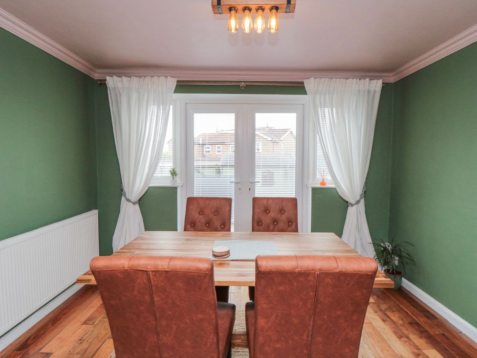 A dining room with a table and chairs at 3 Beck Mews Scarborough
