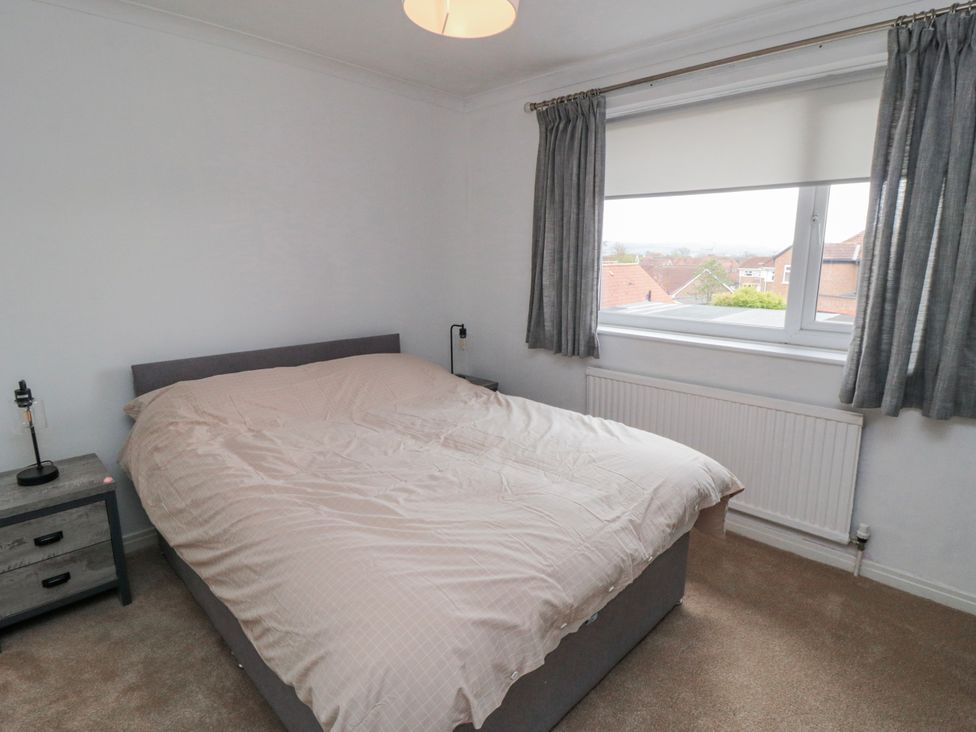 A bedroom with a bed and nightstand at 3 Beck Mews in Scarborough