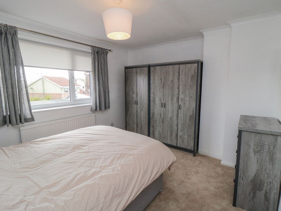A bedroom with a bed and wardrobe at 3 Beck Mews Scarborough