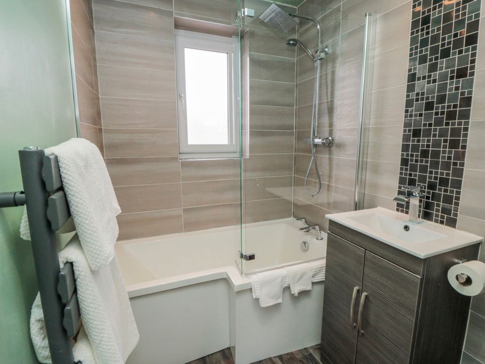A bathroom featuring a bathtub and shower at 3 Beck Mews in Scarborough