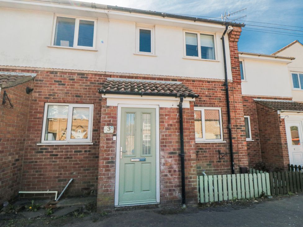 A house exterior with a door and windows at 3 Beck Mews in Cayton