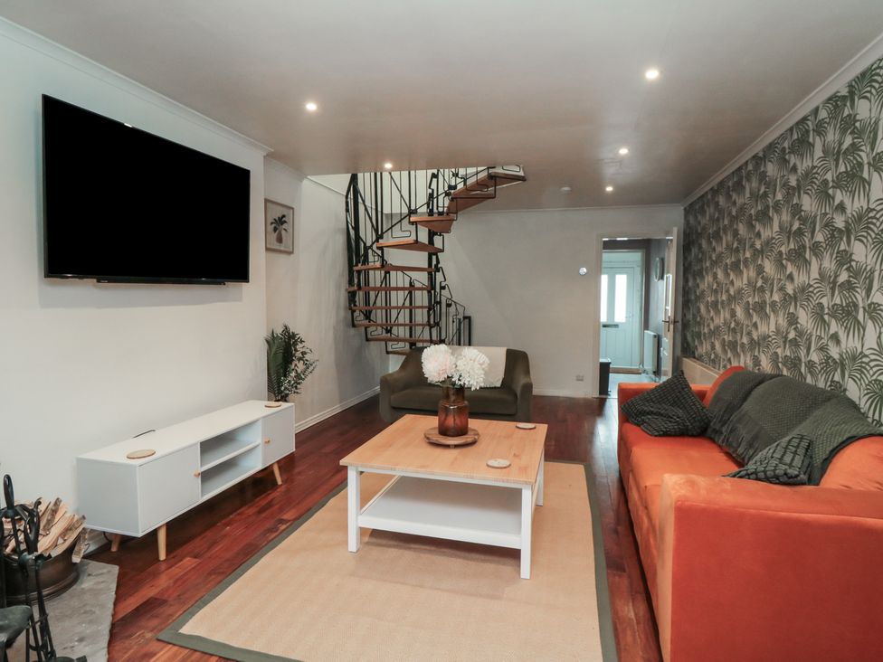 A living room with a sofa and coffee table at 3 Beck Mews in Cayton