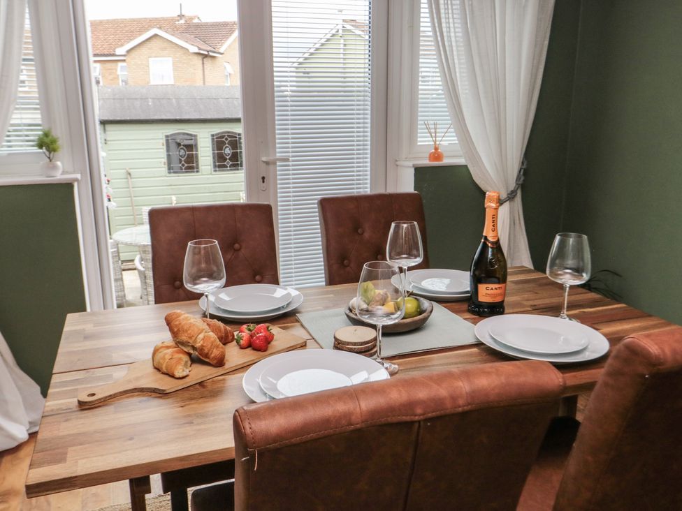 A dining room with a table set for a meal at 3 Beck Mews in Cayton