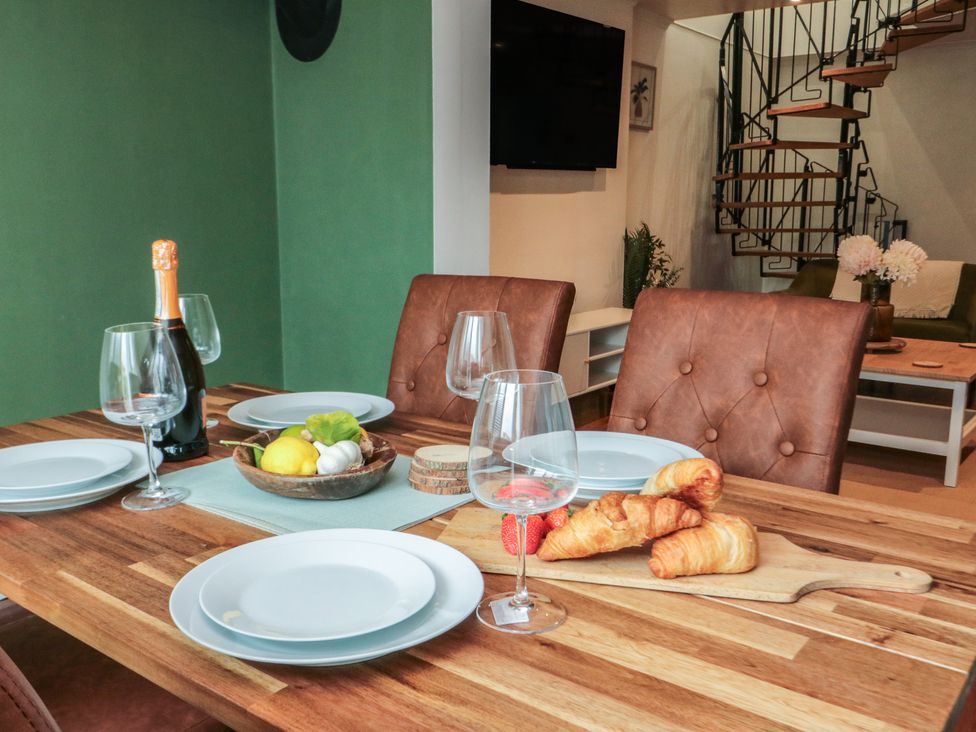 A dining room with a table set for four at 3 Beck Mews in Cayton