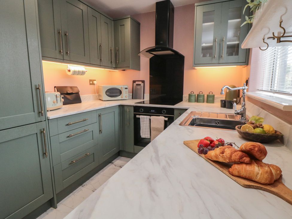 A kitchen with cabinets and appliances at 3 Beck Mews in Cayton