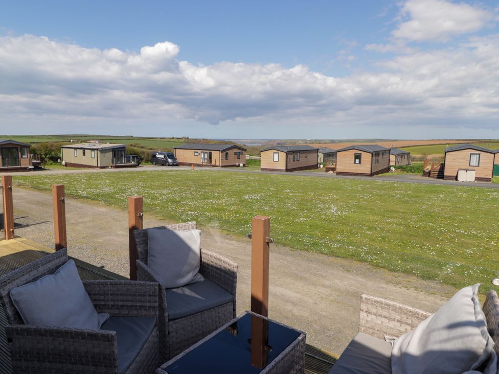 An outdoor area with caravans and seating at Stone Crab Lodge Haverfordwest