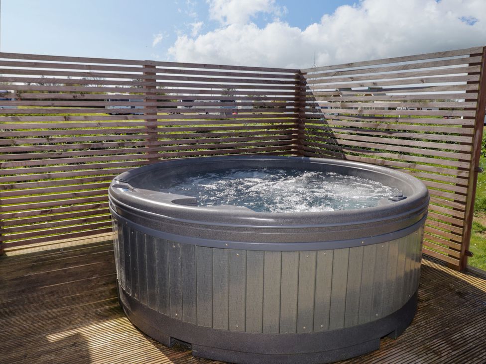 A hot tub in an outdoor area at Stone Crab Lodge in Haverfordwest
