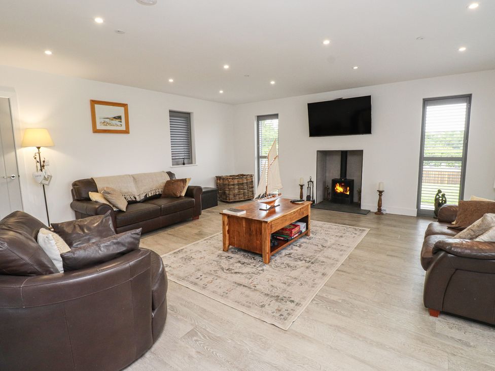 A living room with sofas and a fireplace at Ty Hebog 