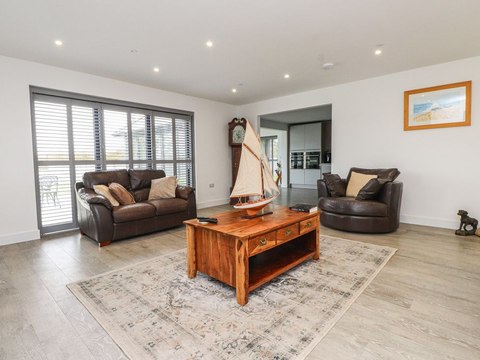 A living room with a sofa and armchair at Ty Hebog 