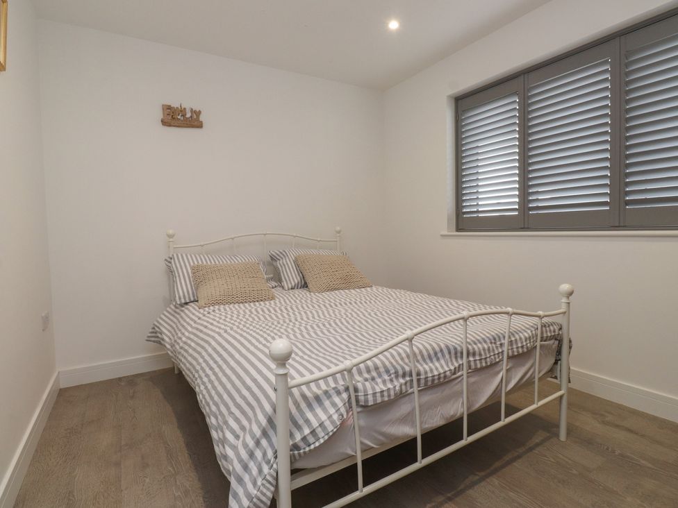 A bedroom with a bed and window at Ty Hebog