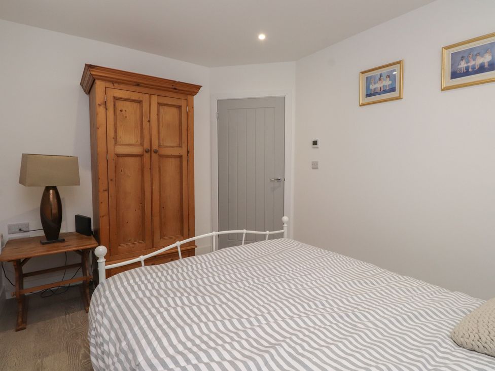 A bedroom with a bed and wardrobe at Ty Hebog