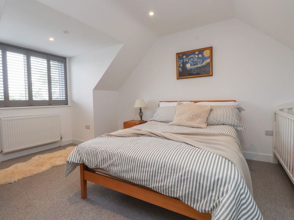 A bedroom with a bed and window at Ty Hebog
