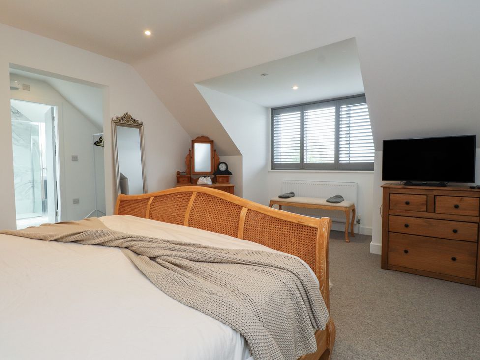 A bedroom with a bed and a dresser at Ty Hebog