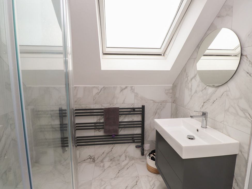 A bathroom with a shower and a sink at Ty Hebog