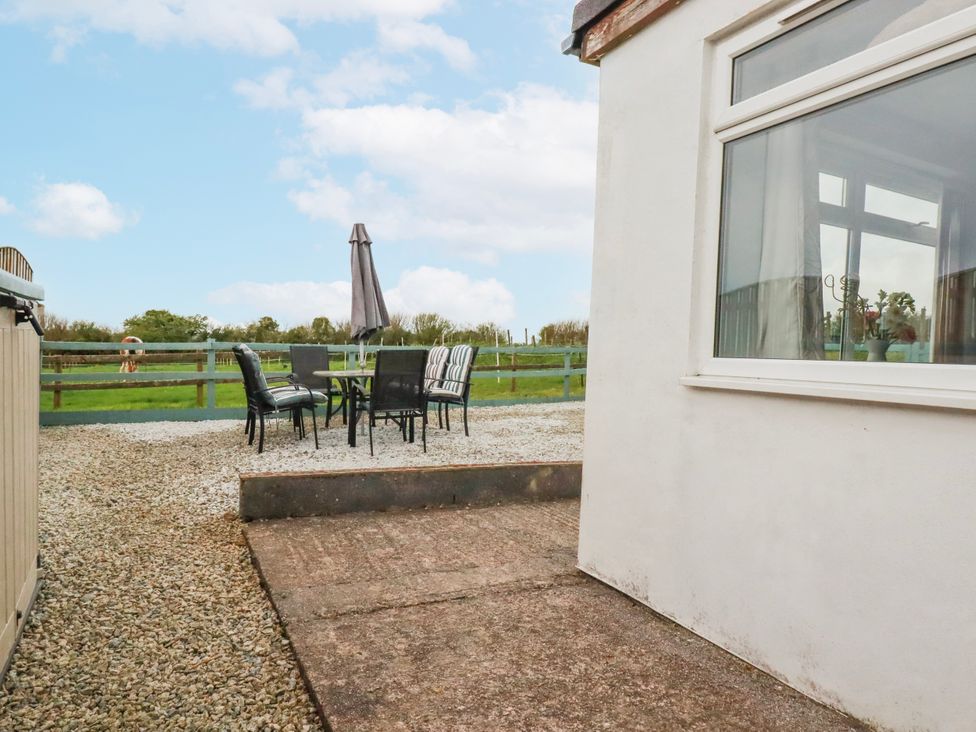 An outdoor area with a table and chairs at Likely Sunset in St. Austell