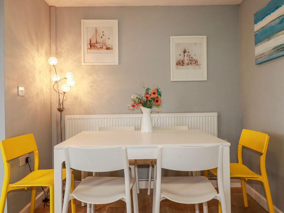 A dining room with a table and chairs at Likely Sunset in St. Austell