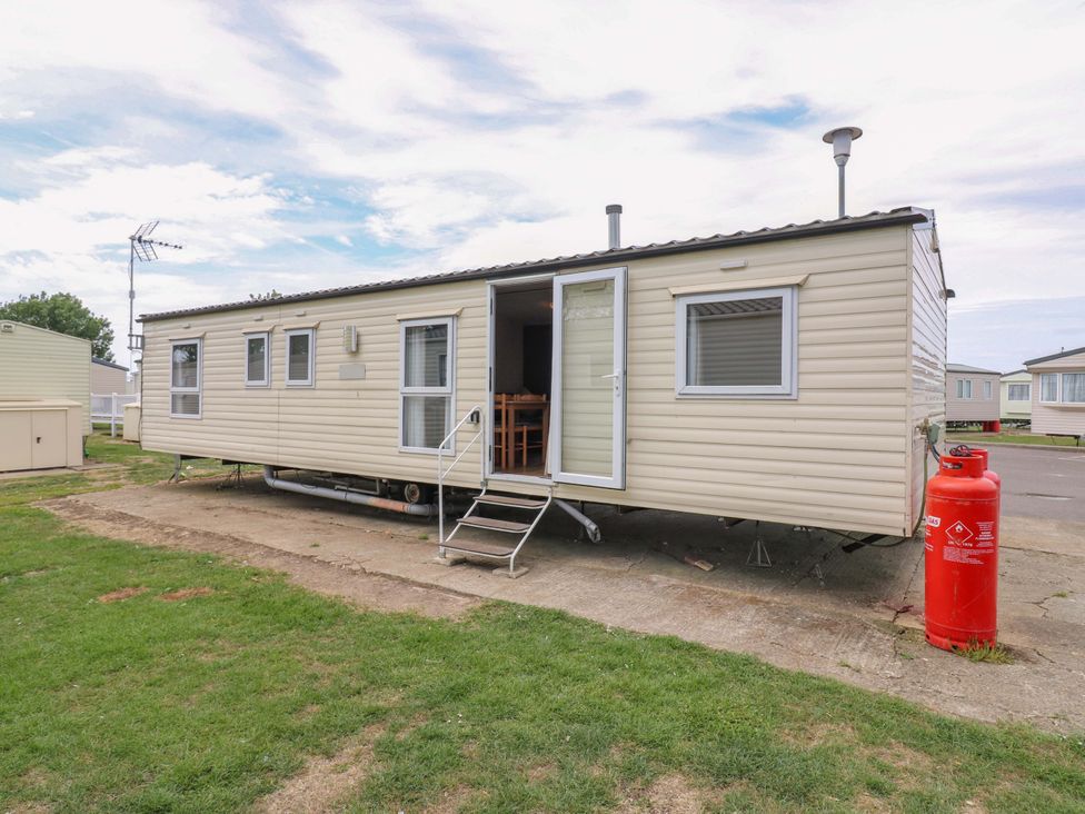 A caravan with steps and a gas cylinder outside Caravan 102 seawick in Clacton-on-Sea