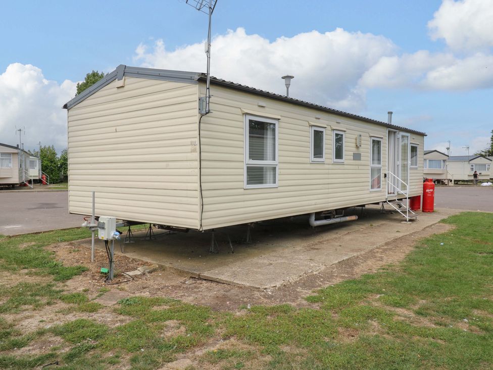 A caravan with steps and windows at Caravan 102 seawick Clacton-on-Sea