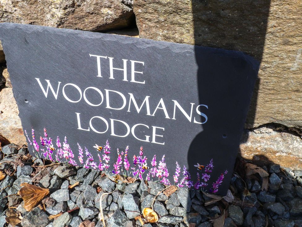 A sign for The Woodman's Lodge at Woodman's Lodge in Llanallgo near Moelfre