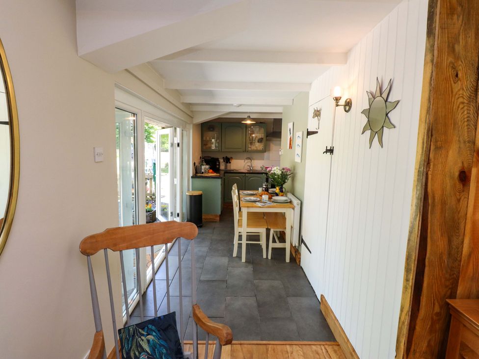 A dining room with a table and chairs at Woodman's Lodge in Llanallgo near Moelfre